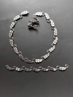 3pc demi-parure c. 1940's Taxco Mexico sterling silver A. Munoz articulated hinged leaf and fine necklace, bracelet and screw-back earrings.  This is a beautiful and elegant Taxco silver set with fantastic details and quality execution that can be work casually & for more formal evening events.  I wear great jewelry with blue jeans and tank tops which I think is a great statement of being a little avant garde / bohemian in attitude and style.  CONDITION:  Excellent vintage w/o damage or repairs. Vintage Silver Jewelry With Matching Earrings, Vintage Sterling Silver Jewelry In Antique Silver, Classic Oxidized Metal Jewelry, Vintage Sterling Silver Jewelry In Silver, Handmade Silver Art Deco Jewelry, Vintage Oxidized Bracelet Jewelry, Handmade Art Deco Silver Jewelry, Vintage Sterling Silver Jewelry For Formal Occasions, Nickel-free Art Deco Sterling Silver Jewelry