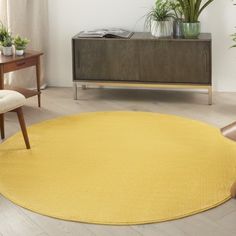 a living room with a yellow rug on the floor