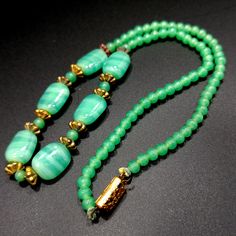 *Description: This necklace is made from faux jade green glass beads that have small air bubbles in them from the 1930s or before. They would be perfect to restring as they are most likely antique beads and the metal plated findings did not hold up as well as the glass beads. Unchecked from a gem tester, you would believe these to be jade but they are indeed glass. Looking closely with a loop, you can see the air bubbles within many of the glass beads. The necklace is 15 inches in length. This w Green Jade Necklaces With Spacer Beads, Green Jade Necklace With Spacer Beads, Green Jade Emerald Necklace With Polished Beads, Vintage Green Aventurine Jewelry, Vintage Jade Beaded Necklace, Adjustable Vintage Jade Necklaces, Adjustable Vintage Jade Necklace, Vintage Adjustable Jade Necklaces, Vintage Adjustable Jade Necklace