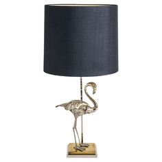 a metal flamingo lamp with a black shade