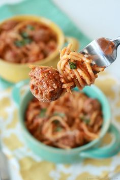 a spoon full of spaghetti and meatballs