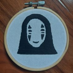 a cross stitch embroidery with a woman's face on it