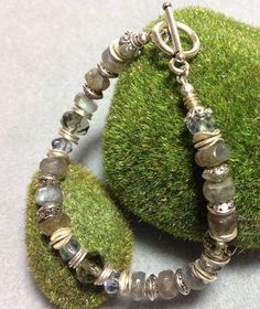 "Beautiful Labradorite and glass faceted bead bracelet with flat and wavy silver discs and pewter beads.  Toggle clasp closure.  Gray/blue tones will go with everything.  6mm to 8mm beads. Very elegant but can be worn casually, too. Select a size under \"Bracelet Length\".  Select a size 1/2\" larger than your actual wrist measurement.  If you need a size that's not on the list just send me a note at checkout.  I suggest measuring your wrist just above your wrist bone.  The bracelet shown here is 6.5\" and fits my 6\" wrist.  Note that the pattern of the bracelet may change slightly as I add more beads for larger sizes.  Every bracelet is made to order and I will ship you a brand new bracelet made just for you. This bracelet looks great alone or stacked with other bracelets. Comes in a rec Silver Beaded Bracelets With Natural Stones For Healing, Silver Crystal Bracelet With Round Gemstone Beads, Silver Bracelets With Natural Stones And Round Beads, Silver Bracelets With Gemstone Beads For Jewelry Making, Silver Beaded Bracelet With Gemstone Beads, Silver Beaded Bracelets With Gemstone Beads, Silver Gemstone Beaded Bracelets, Silver Gemstone Bracelets With Round Beads, Silver Beaded Bracelets With Natural Stones