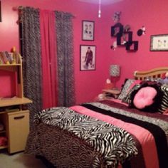 a bedroom with pink walls and zebra print bedding