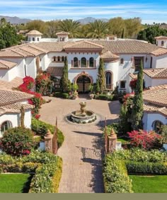 an aerial view of a large home with lots of trees and shrubs in the front yard