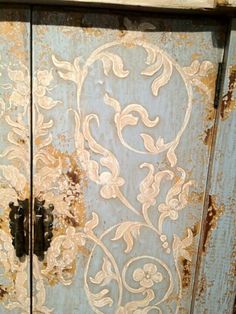 an old blue cabinet with peeling paint on it