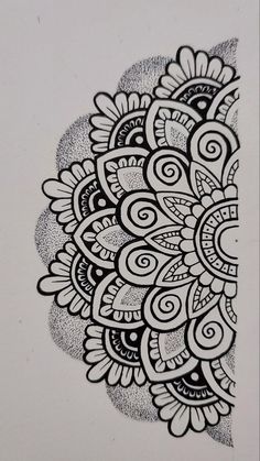 a black and white drawing of an intricate design on a piece of paper with ink