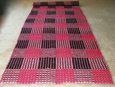 a red and black checkered rug with the price tag $ 84 00 eur