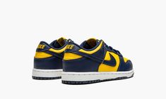 The Nike Dunk Low PS “Michigan” is the preschool sizing of an original colorway of the retro basketball shoe that debuted as part of the “Be True to Your School” collection in 1985.  Known as the original team basketball shoe, the Nike Dunk recaptured its former glory in 2020 when many of the model’s popular colorways, like the “Michigan,” returned to the sneaker landscape.  Created exclusively for the Michigan Wolverines basketball team, the two-tone, blue-and-yellow low-top shoe features Varsi Dunk Low Michigan, Michigan Wolverines Basketball, Retro Basketball Shoes, Retro Basketball, Yellow Nikes, School Collection, Baskets Nike, University Of Michigan, Michigan Wolverines