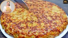 a person cutting into a cheese pizza on a white plate with a woman's face in the background