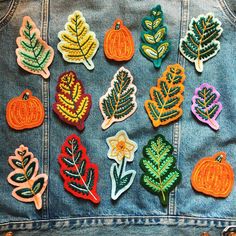 a denim jacket with embroidered autumn leaves on it