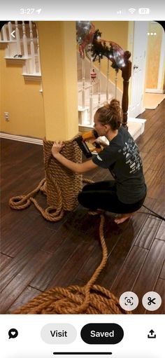 a woman sitting on the floor next to a basket with yarn and scissors in it