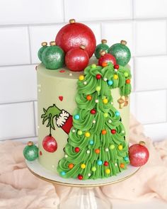 a decorated christmas cake with ornaments on top