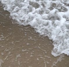 the water is foamy and white on the beach