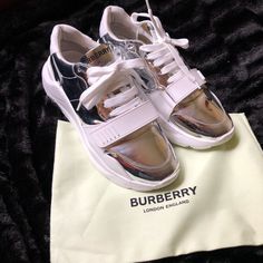 Burberry Regis Metallic Silver Used, They Have Some Minor Scrapes On The Shoes. Posted Pictures To Show Details. No Box No Dust Bag Chunky Sneakers Reworked In Metallic Leather, Set On An Accentuated, Curved Sole. Burberry Lettering At Tongue Embroidered Burberry Lettering At Heel Leather Upper Round Toe Lace-Up Vamp With Grip Tape Closure Polyester And Leather Lining Rubber Sole Made In Italy Burberry Shoes, Burberry London, Chunky Sneakers, Metallic Leather, Mens Shoes Sneakers, Metallic Silver, Rubber Sole, Burberry, Shoes Mens