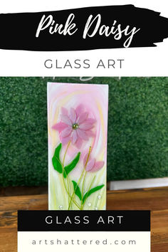 pink daisy glass art is displayed on a table with the words, pink daisy class art