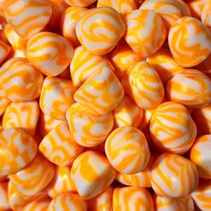 orange and white marbles are piled together