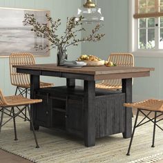 a dining room table with chairs around it and a vase on the table next to it