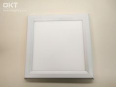 an empty white frame hanging on the wall