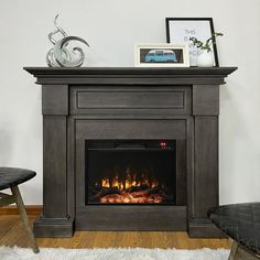 a living room with a fire place in the center and a chair next to it