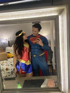 a man and woman dressed up as superman and wonder