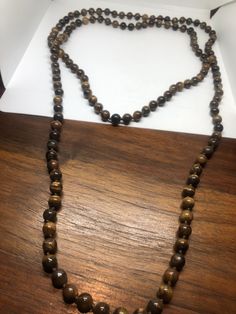 Gorgeous and delicate hand knotted Tiger's Eye long necklace All jewelry is shipped in a nice gift box. Check out our over a THOUSAND great reviews Gift Wooden Beads Long Necklace, Brown Beaded Long Necklace For Gift, Brown Beaded Long Necklace Gift, Elegant Brown Hand-strung Beaded Necklaces, Vintage Brown Long Necklace As A Gift, Elegant Brown Long Necklace With Round Beads, Elegant Brown Beaded Necklace, Gift Hand-strung Brown Beaded Necklaces, Brown Hand-strung Beaded Necklace For Gift