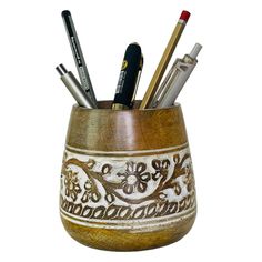 a pen holder with pens and pencils in it