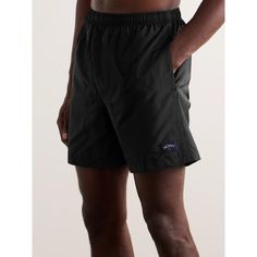 Noah's high-performance swim shorts are streamlined and versatile, making them equally as suitable for warm-weather hikes and runs. Cut from lightweight, quick-drying nylon, they have internal mesh briefs and a drawstring waistband. Black Swim Trunks With Liner For Outdoor, Black Stretch Swim Trunks For Outdoor, Black Stretch Swim Trunks, Black Swim Trunks For Beachwear, Black Beachwear Shorts For Outdoor, Black Technical Fabric Gym Bottoms, Black Swim Trunks With Built-in Shorts For Outdoor, Black Sporty Bottoms In Technical Fabric, Sporty Black Bottoms In Technical Fabric