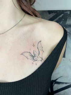 a woman with a bat tattoo on her chest