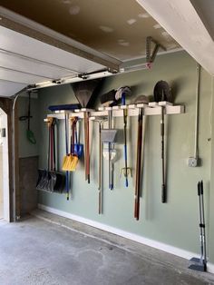 a garage filled with lots of different types of tools hanging on the wall next to each other