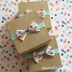 three wrapped gift boxes with bows on them