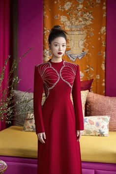 Elevate your style with our exquisite Ao Dai. The luxurious velvet fabric, coupled with the high neck and A-line silhouette, creates a stunning look that exudes sophistication and elegance. Perfect for special occasions and events, this ao dai is sure to make you stand out. Length: 150cm (Ao Dai), 110cm (Pants) Red Velvet Gala Dress, Elegant Red Evening Dress For Winter, Red Fitted Velvet Dress For Banquet, Red Fitted Velvet Dress With Long Sleeves, Fitted Red Velvet Long Sleeve Dress, Elegant A-line Winter Evening Dress, Elegant Winter A-line Evening Dress, Red Fitted Velvet Dress For Weddings, Fitted Red Velvet Dress For Wedding