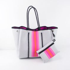 Neoprene tote. Water Resistant. Available in pink/orange strip and Turquoise strip. Material: Neoprene (The same material that wet-suits are made of.) Dimensions:Tote: 14.2" length left to right looking at face of bag15.4" height9.8" base front to back widthPouch: 7.75" x 5.5 " Neoprene Bag, Neoprene Tote, Oversized Tote Bag, Carryall Tote, Oversized Tote, Bungee Cord, Orange Crush, Mini Pouches, Small Pouches