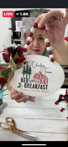 an older woman holding up a plate with the words bed and breakfast written on it