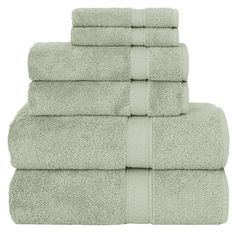 six towels stacked on top of each other in light green color, with one folded and the