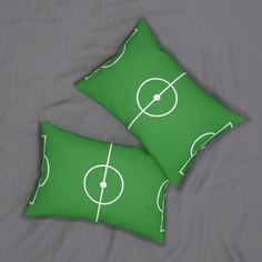 two green pillows with white lines on them and a soccer field drawn on the pillow