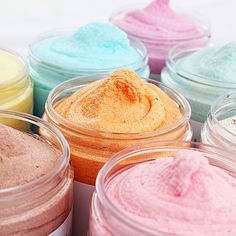 there are many different colored powders in small jars