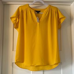 New With Tags. Size Small. Casual Yellow V-neck Top, Gold Short Sleeve Top For Summer, Gold Casual Shirt For Spring, Casual Gold Shirt For Spring, Yellow Relaxed Fit Top For Work, Fitted Mustard Top For Work, Mustard Fitted Tops For Work, Yellow V-neck Summer Shirt, Gold Fitted Casual Blouse