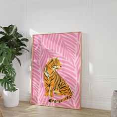 a tiger sitting on top of a wooden floor next to a potted plant