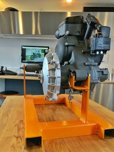 an industrial engine sitting on top of a wooden table