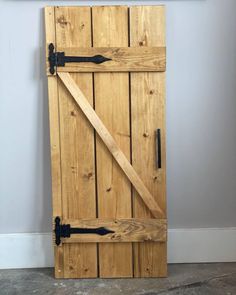 a wooden door with two black handles on it