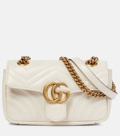 GG Marmont Mini crossbody bag in white - Gucci | Mytheresa White Crossbody Shoulder Bag With Gold-tone Logo, White Crossbody Bag With Gold-tone Logo Plaque, Designer White Shoulder Bag With Gold-tone Logo, Designer White Bags With Gold-tone Logo Plaque, Designer White Bags With Gold-tone Logo, Classic Quilted Gucci Shoulder Bag, Modern Gucci Shoulder Bag With Logo, Chic Gucci Shoulder Bag With Logo, Modern White Gucci Bag