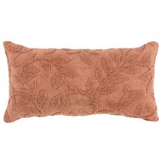 an orange decorative pillow with leaves on the front and back, sitting on a white background