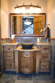 a bathroom with wooden cabinets and a round sink