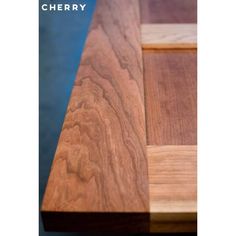 a close up view of the top of a wooden table with text that reads cherry