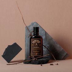 a bottle of shaving soap next to a stone