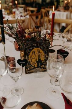 the table is set with wine glasses, plates and napkins for an elegant dinner