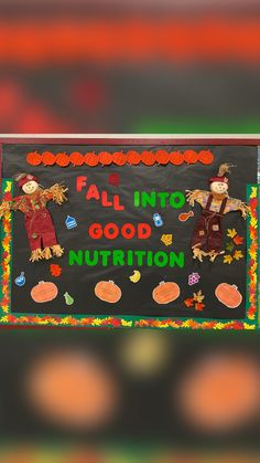 two scarecrows are standing in front of a sign that says fall into good nutrition