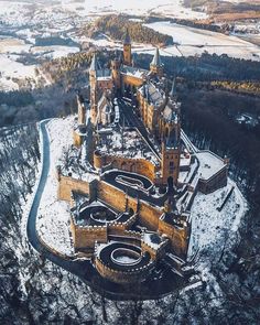 an aerial view of a castle in the middle of winter with snow on the ground