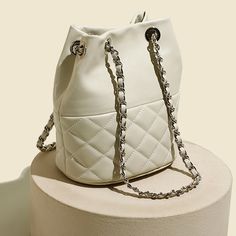 Strike the perfect balance between chic and cool with our quilted bucket bag. Featuring a relaxed, circular silhouette, this roomy piece will ensure that you will have ample space to hold your daily essentials and more with ease. The soft quilted finish is a timeless classic that will never go out of fashion — it will also add visual interest to your look. Pair it with a white lapel blouse, tapered jeans and loafers.Weight: 460 gWidth (cm): 18 cmHeight (cm): 22.5 Color: WhiteInterior Material: C Luxury Bucket-shape Shoulder Bag For On-the-go, Chic Quilted Shoulder Bag, Chic Cream Quilted Shoulder Bag, Trendy Quilted Pouch Shoulder Bag, Chic White Quilted Bag, Modern Bucket Shoulder Bag With Chain Strap, Chic Quilted Tote Bags, Chic Quilted Bag With Double Handles, Chic Quilted Shopping Bag